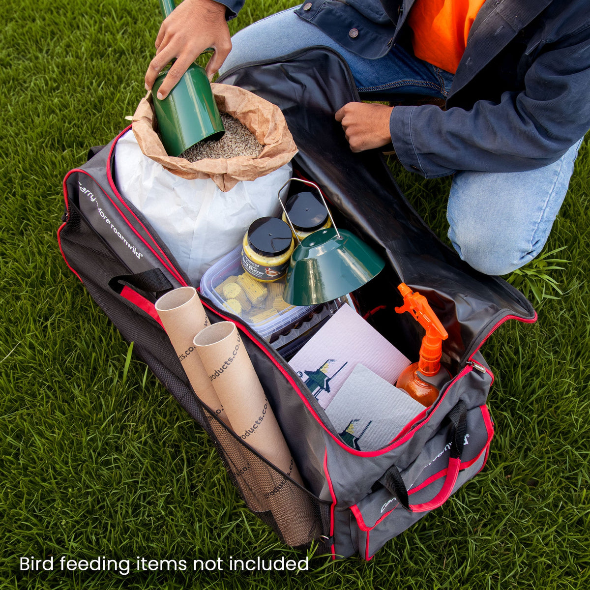 Carry-More open on the lawn, packed with bird seed, fat feeds, a spray bottle and cloths (items not included)
