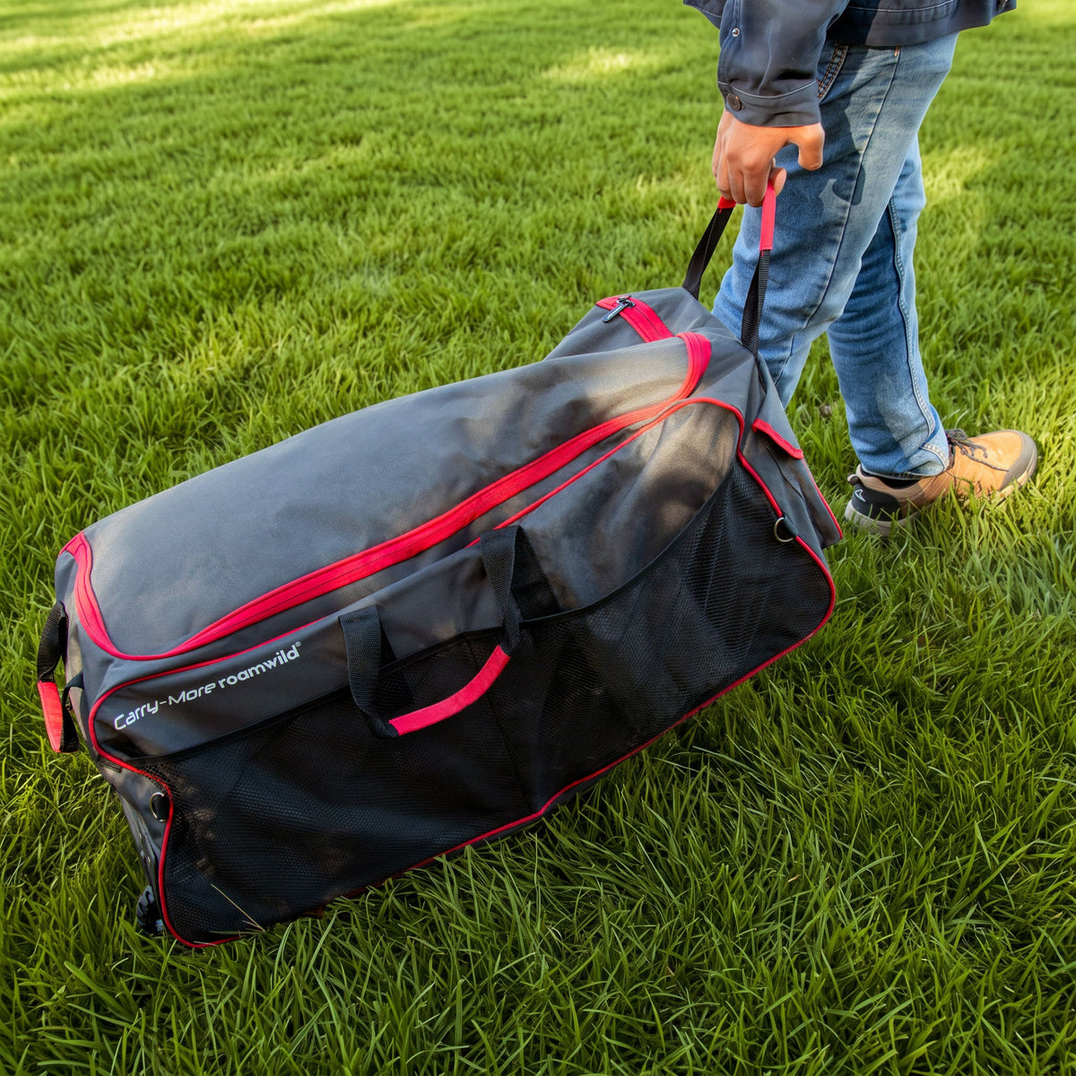 Carry-More being wheeled across a garden lawn