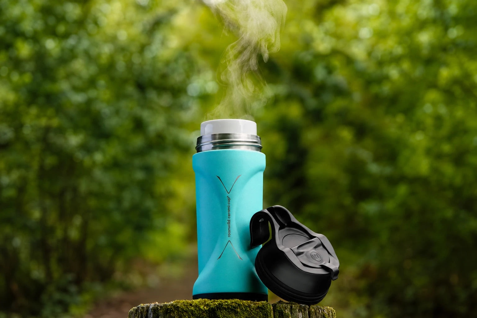 Roamwild Cerami Cup in teal on a mossy stump, woodland